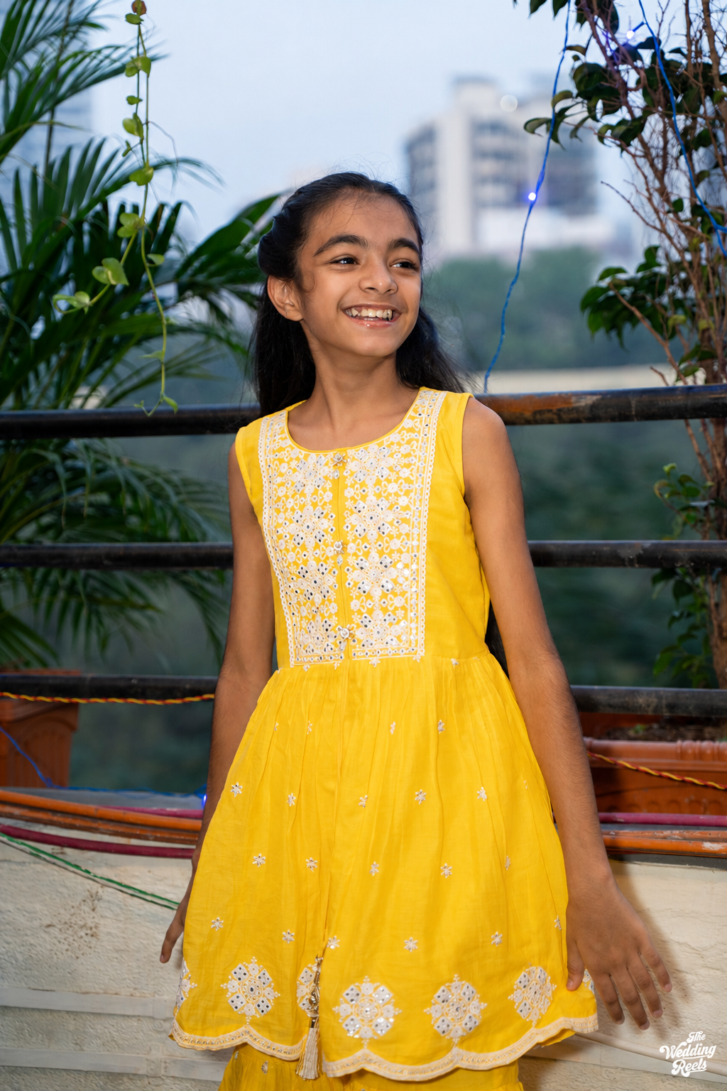 A smiling young Entrepot Royals supporter dressed in yellow